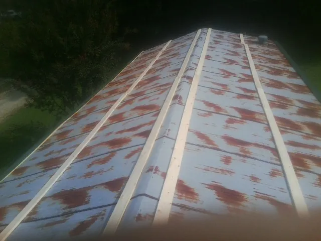 Rusted metal roof panels with new wood purlins before replacement — Storm Damage Roof Repair in Bonlee by Roofing Brothers